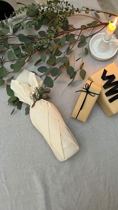 some candles are sitting on a table with napkins and other items next to it