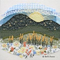 a patchwork piece with flowers and mountains in the background