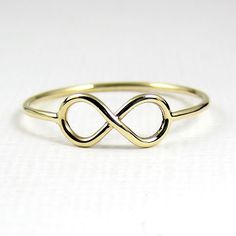 Solid Gold infinity ring in 9 or 18 karats This cute and dainty ring has been hand forged by myself and will be a sweet little addition to any jewellery collection. The infinity sign has been reclaimed by romantics to signify love without end, constantly recurring. Makes a great gift for so many people in your life...mother, daughter, partner or wife, what better way to say 'you're loved'. Each ring is handmade by myself, formed finished and tumble polished for several hours for added strength, shine and lustre. This listing is for one (1) ring made with 18g (1mm) Solid gold round wire with a highly polished finish. The infinity symbol measures approximately 12mm long by 5.5mm high. Available in sizes US 4-10, UK H-T1/2 in most instances. Please make a selection in the dropdown box. If you Adjustable 14k Gold Infinity Ring, 14k Gold Infinity Ring, Gold Infinity Ring, Infinity Sign, Zierlicher Ring, Monogram Ring, Solid Gold Ring, Infinity Ring, Initial Ring