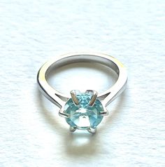 A beautiful sky blue topaz is mounted in a 925 silver claw setting. It measures 8mm in diameter. The ring is a small size K/L in UK sizing. The colour is absolutely lovely and it is beautifully cut. Solitaire Aquamarine Ring Round Cut, Blue Aquamarine Solitaire Ring, Blue Topaz Solitaire Ring With Round Band, Light Blue Ring With Prong Setting, Light Blue Brilliant Cut Topaz Ring As Gift, Light Blue Brilliant Cut Topaz Ring For Gift, Light Blue Topaz Ring In Sterling Silver, Light Blue Topaz Ring With Sterling Silver, Blue Solitaire Topaz Ring With Round Stone