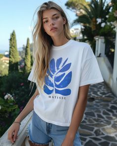 Elevate your style with our Exclusive Blue Matisse Plant Graphic Tee, a perfect blend of vintage inspiration and modern artistry.  This unisex t-shirt features an original artist-made design inspired by Henri Matisse's iconic plant motifs, bringing a touch of French elegance to your wardrobe. Made from premium, 100% soft cotton, this tee offers both comfort and style, making it ideal for any casual occasion or as a unique gift for art lovers. Embrace the artistry of the coast with this standout Blue Relaxed Fit T-shirt With Plant Print, Blue Bohemian Graphic Print T-shirt, Artistic Blue Crew Neck T-shirt, Blue Tropical Graphic Print T-shirt, Blue Matisse, Plant Graphic, Blue Organic Cotton T-shirt With Screen Print, Lovers Embrace, French Elegance