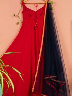 This is two-piece Red Anarkali set from the Anisha Shetty collection. This beautiful red georgette anarkali is paired with a net navy blue dupatta. The red color with a tassel tie-up at the back enhance this anarkali set. The navy blue dupatta has the golden floral lace border detail.
Churidar NOT included. Traditional Anarkali Set With Tassels For Designer Wear, Designer Anarkali Set With Tassels For Diwali, Designer Anarkali Set For Navratri With Tassels, Navratri Designer Anarkali Set With Tassels, Designer Anarkali Set With Traditional Drape And Tassels, Anarkali Designer Lehenga With Tassels, Designer Wear Anarkali Set With Tassels, Eid Anarkali Set With Tassels, Designer Anarkali Set With Tassels