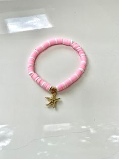 This bracelet is made out of stretchy string and clay beads. It's so pretty for summer! All orders will recieve 2 stickers and a ring for free. Starfish Clay Bead Bracelet, Snowflake Making, Bracelet Preppy, Bead Bracelet Ideas, Make Clay Beads, Pink Starfish, Bracelet Business, Bracelet Stuff, Colorful Bead Bracelets