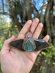 a hand holding a butterfly shaped key chain