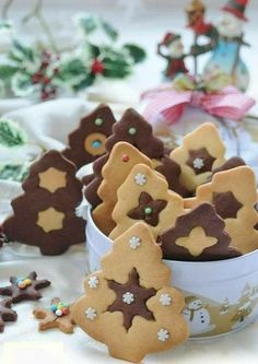 several decorated cookies in a bowl on a table