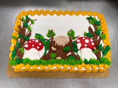 a decorated cake with mushrooms and trees on it