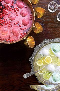 a bowl filled with ice and lemons next to another bowl full of watermelon