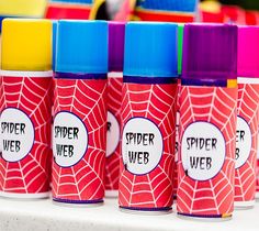 colorful spider web cups lined up on a table