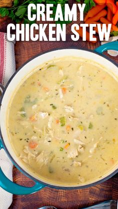 creamy chicken stew in a blue pot with carrots and celery on the side