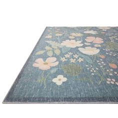 a blue rug with flowers on it