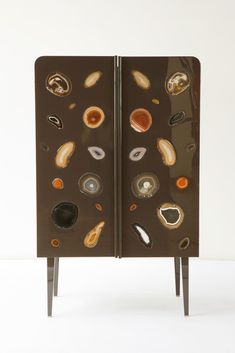 an art piece with many different shapes and sizes on the front, in brown color