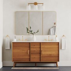 a bathroom vanity with two mirrors above it