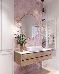 a bathroom with a sink, mirror and plant on the counter in front of it