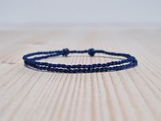 Simple dark blue string bracelet, made from a nylon cord.  The bracelet has an adjustable size thanks to the sliding knot. This a simple fabric jewelry that can be worn alone or stacked with other bracelets. Suitable for both men and women. The bracelet is fully water-resistant, so you can swim and shower with it. - - - - - - - - - - Materials: Nylon cord - Color: Dark Blue - - - - - - - - - Adjustable size - Open from 15cm (5.9") to 25cm (9.8"). - - - - - - - - - - More slip knot bracelets colo Casual Navy Bracelet As A Gift, Casual Navy Bracelets For Gifts, Blue Resizable Braided Bracelet For Everyday, Adjustable Sliding Knot Nylon Thread Bracelets, Everyday Resizable Blue Braided Bracelets, Everyday Blue Resizable Braided Bracelets, Blue Nylon Cord Friendship Bracelets With Sliding Knot, Blue Sliding Knot Friendship Bracelets In Nylon Cord, Blue Waxed Cord Braided Friendship Bracelets