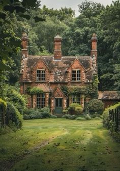 an old brick house surrounded by greenery and trees in the country side, with a green door