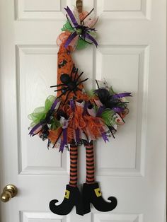 Here's a super cute "funky" witch's hat to adorn your door, entranceway, or any room in your home.   If you're a Halloween lover, this wreath will bring the festivity of the holiday to your home, greeting friends and family... and, yes, Trick or Treaters.  Made with glittery Halloween fabric sporting bats, spider webs, ghosts, and more,  2.5" "Happy Halloween" ribbon, and 7/8" purple glittery ribbon.  It's adorned with a cute green spider at the tip of the hat and a large black spider right on the front. Dimensions:  36" Long by 18" Wide NOTE:  Best if displayed on a covered porch, or indoors, away from wind, rain, snow, and sun, as it can fade and wear faster. Witch Wreaths For Front Door Office, Sabta Hat Doir Wreath, Turkey Wreath Deco Mesh Witch Hat, Dollar Tree Witch Hat Wreath Form Gnome, Witch Wreath Christmas, Witch Hat Santa Wreath, Christmas Wreath Using Witch Hat Form, Dollar Tree Wire Witch Hat Form, Scarecrow Witch Hat Wreath