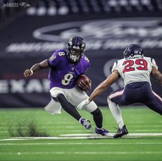 a football player running with the ball in his hand and another person behind him on the field