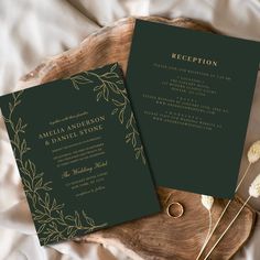 two green wedding cards on top of a wooden plate