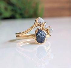 a close up of a gold ring with blue and white stones on it's sides