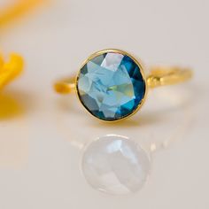 10% Off - Blue Topaz Ring - Bezel Ring - London Blue Topaz Ring - Gemstone Ring- Gold Ring - December Birthstone -Size  5. $62.00, via Etsy. Blue Topaz Round Band Ring, Blue Topaz Birthstone Ring With Round Band, Faceted Blue Topaz Ring, Blue Topaz Round Band Jewelry Gift, Gift Crystal Topaz Ring With Round Cut, Topaz Crystal Ring With Round Cut For Gift, Blue Topaz Round Band Jewelry For Gifts, Adjustable Blue Topaz Promise Ring, Blue Faceted Sapphire Ring In Fine Jewelry Style