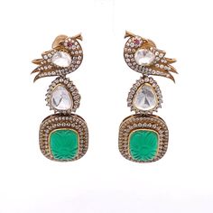 This Traditional Bollywood inspired Indian Earring is studded with fine quality Moissanite and Green stone. It shows the elegance and grace of the earrings. A finely crafted Jewelry in 925 Silver, this is an absolutely real looking Indian style earring with high carat gold plated silver. The beautiful Parrot design on the top accentuates the look and makes it stand out. Gross Weight: 38.07 gms Dimensions: 64 x 23mm You can also go to our shop Home for more: https://www.etsy.com/in-en/shop/TempusGems Packaging and Shipping Your item is packed very carefully to avoid any in-transit damage. We first pack it in a zip pouch and then put it in a Bubble Pouch.  Your order is processed currently in 3-5 business days.  We use Standard Shipping services to ship your order. We are currently offering Jadau Earrings, Parrot Design, Earring Bridal, Polki Earrings, Indian Earrings, Ancient Jewelry, Moissanite Jewelry, Indian Style, Crafted Jewelry