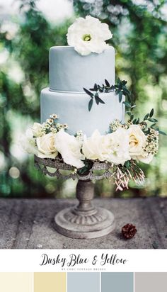 a wedding cake sitting on top of a table with white flowers and greenery in the background