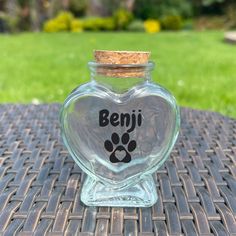 a glass jar with a paw print on it