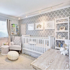 a baby's room is decorated in gray and white