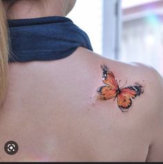 a woman with a butterfly tattoo on her back