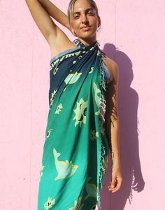 Vintage beach sarong in blue and green dolphin print. Tassles to edges. Multi use, wear as a sarong, beach cover up or use as a beach towel. Lightweight breathable fabric. Size: 44"(112cm) x 64"(163cm) Composition: Rayon Green Tropical Sarong For Pool, Tropical Green Printed Sarong, Beachy Green Sarong For Beach Season, Green Hawaiian Sarong For Summer, Green Hawaiian Sarong For Beach Party, Green Tropical Sarong For Poolside, Tropical Green Sarong For Poolside, Green Summer Sarong For Pool, Bohemian Green Sarong For Beach Cover-up