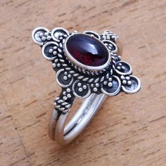 For a dreamy accessory to add to your wardrobe this cocktail ring is designed by Bali's Ketut Sulastri. She handcrafts the ring of sterling silver with an intricate crown that is centered by an oval cabochon of gleaming red garnet. Dream Jewelry, Jewelry Packaging, Red Garnet, Oval Cabochon, Cocktail Ring, Jewelry Gift Box, Free Jewelry, Cocktail Rings, Garnet