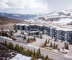 an aerial view of a large apartment building in the middle of a snow covered mountain