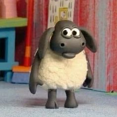 a cartoon sheep is standing on the floor