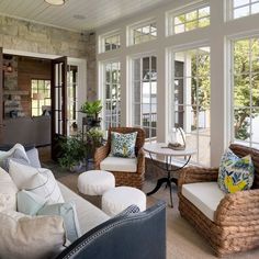 a living room filled with furniture and lots of windows