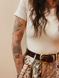 a woman with tattoos on her arm and arms