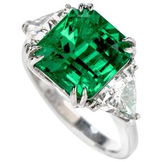 Dover Jewelry Present this Stunning Square Colombian Emerald Diamonds handcrafted is solid platinum. Displaying vibrancy and elegance, it is centered with 1 genuine square cut Emerald extremely fine in color and clarity, weighing approx. 5.81carats, measuring 10.78mm X 10.23mm X 8.53mm, GIA certified set in claw prongs. This rare Colombian emerald Flanked in between 2 genuine triangular cut Diamonds approx. 1.90 carats, F-G color, VS1 clarity, Set in prong. This classic Ring is in New condition. Most Expensive Emerald Ring, Tahitian Pearl Ring, Wide Wedding Rings, Colombian Emerald Ring, Contemporary Engagement Rings, Emerald Rings, Emerald And Diamond Ring, High Jewellery, Ruby Diamond Rings