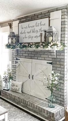 a brick fireplace with white flowers and greenery