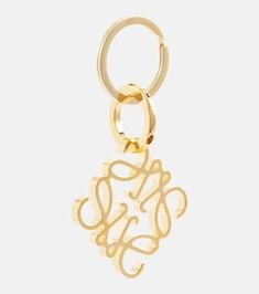 Let your devotion to LOEWE seep into all aspects of life with this Anagram keyring. Made from gold-toned brass, it suspends the label's signature motif - originating from countryside cattle breeding in the label's native Spain - and an engraved moniker. Style with the coordinating accessories, or gift to a fellow label lover..Made in Spain.Material: brass.Length 8,6cm-3.5'.Width 4,9cm-2' Metal Pendant Jewelry With Gold-tone Logo Plaque, Logo Charm Keychains For Gifts, Gift Keychain With Logo Charm, Gold Keychain With Logo Charm As Gift, Gold Jewelry With Metal Logo For Gifts, Gold Jewelry With Metal Logo As A Gift, Gold Metal Keychain For Gift, Gold Metal Keychain Perfect For Gifts, The Daily Edited