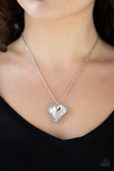 Chiseled into a charming heart, an oversized white rhinestone gem is nestled inside a sleek silver frame, creating a flirtatious pendant below the collar. Features an adjustable clasp closure. Sold as one individual necklace. Includes one pair of matching earrings. P2RE-WTXX-475XX Formal Silver Heart-shaped Diamond Necklace, White Heart-shaped Diamond Necklace With Accents, Nickel-free Heart-shaped White Necklace, Diamond White Heart-shaped Sterling Silver Necklace, Silver Heart-shaped Necklace With Rhinestones, Short Silver Necklace, Paparazzi Accessories Jewelry, Heart Flutter, Silver Heart Pendant