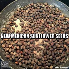 a pan filled with lots of beans and the words new mexican sunflower seeds above it