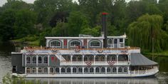 a large white boat with red, white and blue decorations on it's side