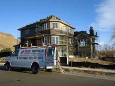 a white van parked in front of a house under construction