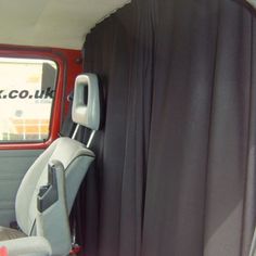 the interior of an old car with black drapes on it's side window