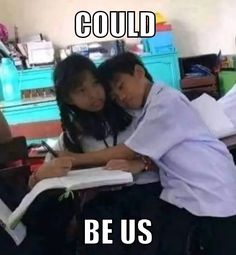 two people sitting at a desk with books and papers in front of them, the caption reads could be us