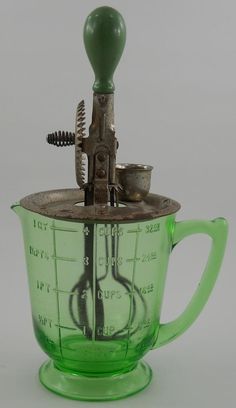 a green blender sitting on top of a table