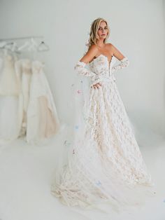 a woman in a wedding dress posing for the camera