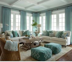 a living room filled with furniture and lots of blue drapes on the window sill