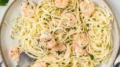 pasta with shrimp and parsley in a white bowl