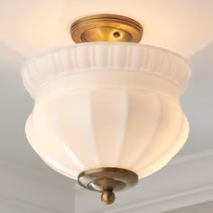 a white light fixture hanging from the ceiling