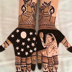 two hands with henna designs on them